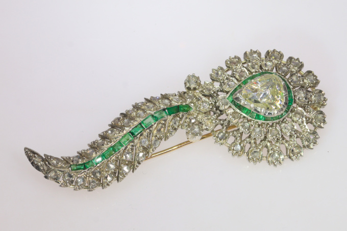 Antique brooch with large pear shaped rose cut diamond and set with many rose cut diamonds and carre cut emeralds by Artista Sconosciuto