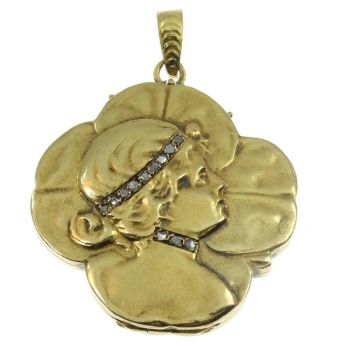Typical Art Nouveau gold locket woman head on four leaf clover by Unknown Artist