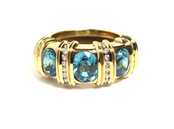 Ring with three turqouise blue Zirkons in yellow gold and brillant cut diamonds by Puck Eigenmann