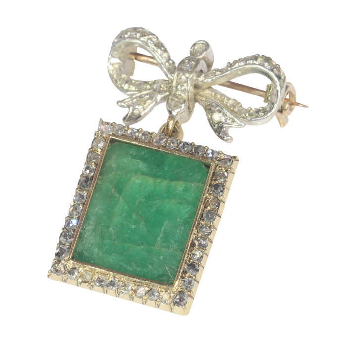 Antique Victorian diamond bow brooch with large emerald pendant hanging underneath by Artista Sconosciuto