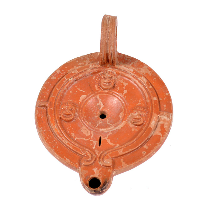  A Roman terracotta red slip ware oil lamp with theatre masks by Unknown artist