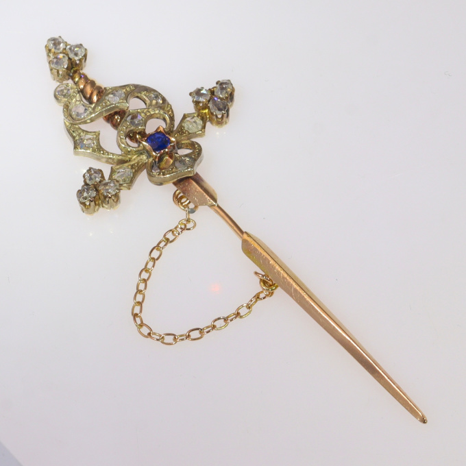 Vintage pin in the form of a sword set with diamonds and a sapphire by Unknown Artist