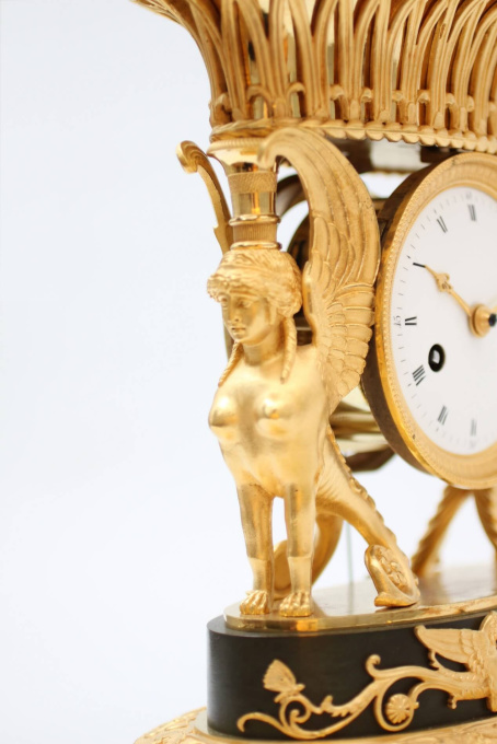 A French Empire ormolu urn mantel clock with griffins, circa 1800 by Artiste Inconnu