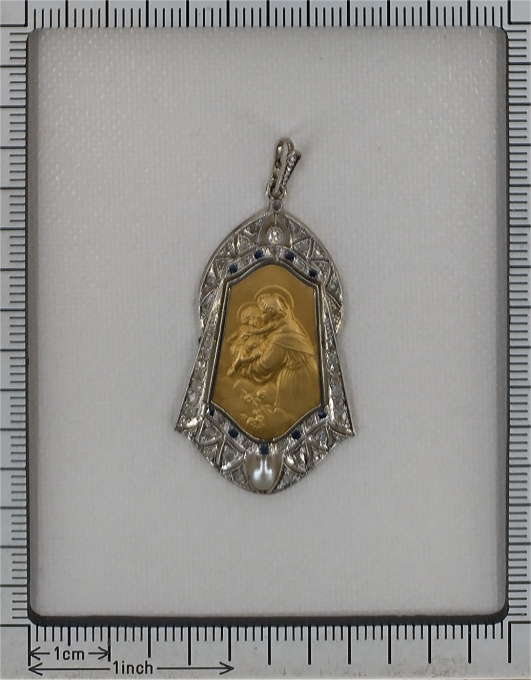 Vintage 1910's medal 18K gold pendant set with diamonds sapphires and pearl St. Anthony of Padua depicted holding the Child Jesus by Artiste Inconnu